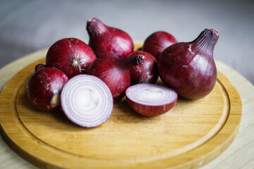 Red onion on the wooden board