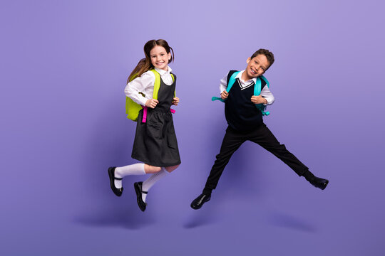 Photo of positive buddies pupils jump wear school bags buying on low price discounts isolated bright color background