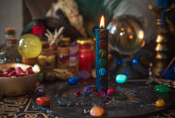 Candle burns on the altar, magic among candles, clean negative energy, wicca concept	