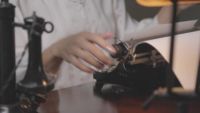 Dolly right woman using 1930s typewriter