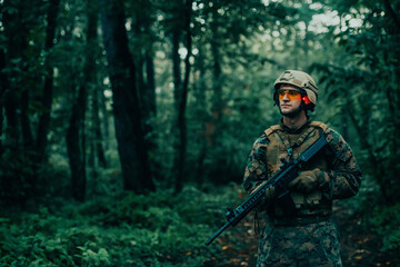 A modern warfare soldier on war duty in dense and dangerous forest areas. Dangerous military rescue operations