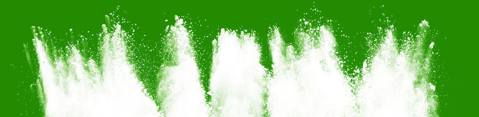 White color holi paint color powder explosion isolated on green wide panorama background