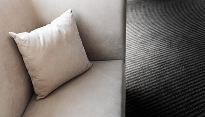 Single pillow lying on the corner of sofa
