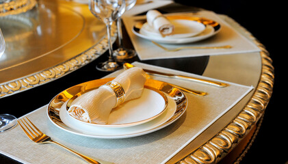 Fork and knife on a napkin with plate, elegant dinner