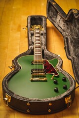 Vintage-style green electric guitar in a protective case