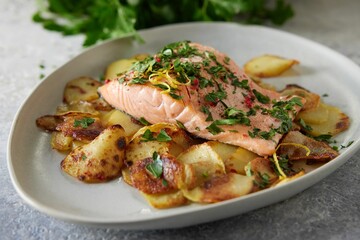 a plate full of food with potatoes and salmon on it