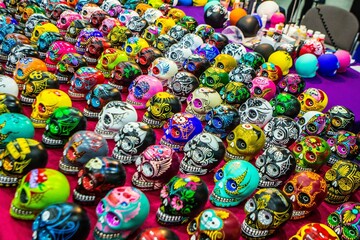 Fototapeta na wymiar Assortment of vibrant, traditional, Mexican souvenir skulls on display at a local market