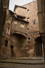 Fototapeta na wymiar Scenic view of a street with brown buildings in Siena, Italy