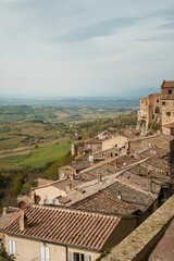 Fototapeta na wymiar Gorgeous view of the lush agricultural fields and buildings of Montepulciano, Italy