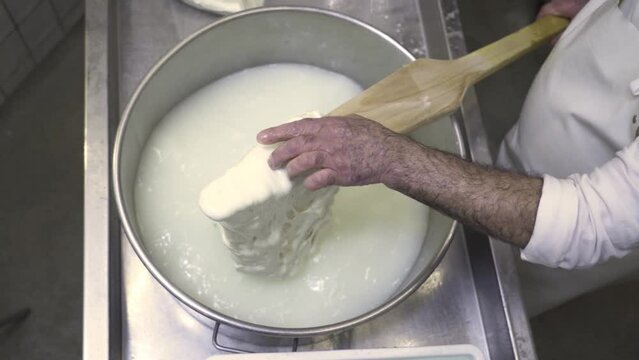 Process of making cheese from milk in a saucepan by a cook