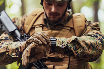 American marine corps special operations soldier preparing tactical and commpunication gear for...