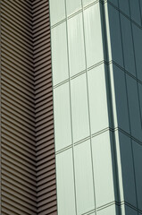 Fototapeta na wymiar Green and Tan Building Corner Wall with Facade.