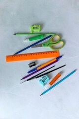School supplies lie on a white table