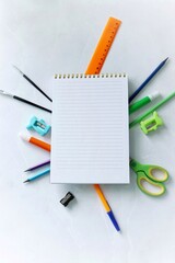 School supplies and a notebook lie on the table