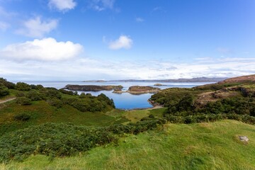 Fototapeta na wymiar Scenic coastal landscape surrounded by greenery in Drumbeg, Scotland