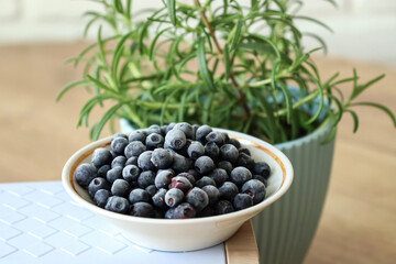 Blueberries and a flower on a wooden table