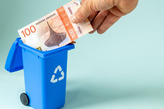 Norway money, Withdrawing cash from the market, Business concept, Paper banknote of 100 norwegian kroner thrown into the bin, copy space
