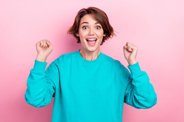 Photo portrait of lovely young lady raise fists excited shout yeah lottery dressed stylish blue...
