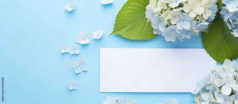 Poster a top-down view of a beautiful composition featuring hortensia flowers and a blank card on a light b