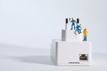 workers repair a white power plug , miniature figures scene, white background.
Skilled workers...