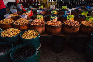 Different olives sale in the traditional farm Turkish market, a counter filled with fresh fruits