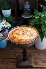 Round pizza on the shop window. Cooking flour products, rustic style