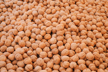Walnut sale in the traditional farm Turkish market, a counter filled with fresh fruits