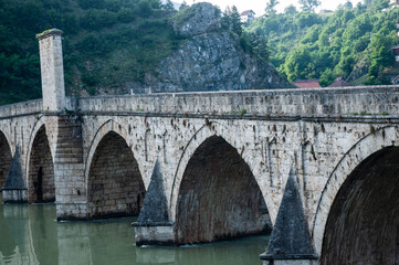 Fototapeta na wymiar Bridge on river Drina, famous historic Ottoman architecture in Visegrad, Bosnia and Herzegovina. Mehmed-pasa Sokolovic bridge.