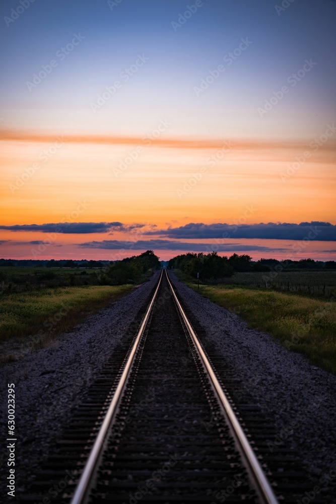 Aufkleber scenic view of a railway track passing through an expansive meadow