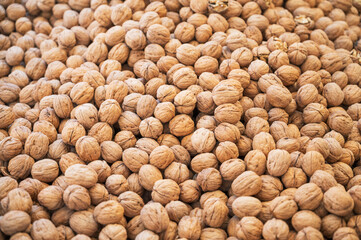Walnut sale in the traditional farm Turkish market, a counter filled with fresh fruits