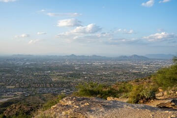 Aerial view of Phoenix, Arizona, showcasing the city's rocky terrain and lush greenery