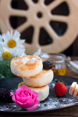 curd cheesecakes on a black plate. Grocery still life, cooking recipe