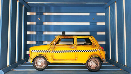 Mockup of a vintage yellow taxi car. Toy car as decor. Taxi in a wooden painted cube, box 

