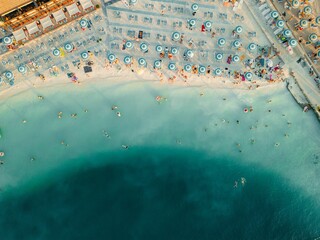 Aerial view o of people enjoying a sunny day at the beach in Selce, Croatia