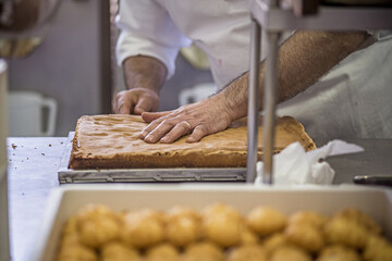 Production of delicious desserts and cakes with cream, and strawberries in a confectionery factory in Sicily, Italy