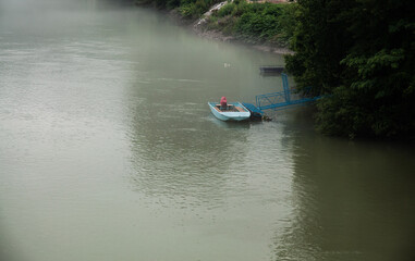 Blue fisher boat on the river, Bosnia and Herzegovina.