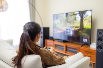 Woman play video game at home