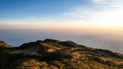 Obraz premium The beautiful Landscape view from Lawu Mountain at sunrise located in Magetan. One of the most beautiful mountains in Java with an altitude of 3265m above sea level. 