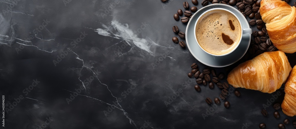 Poster Fresh croissants and coffee placed on a stone table as seen from above, with empty space for adding