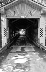 Vintage and historic wooden covered bridge on empty road