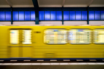 yellow subway train car rides at the station