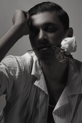 portrait of a man holding flower in mouth with emotion