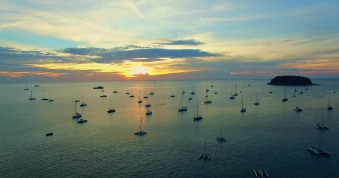 every year on the first week of December they have yacht king cup racing in Phuket..Kata beach is the marina of yachts..Yachts in the marina background.Beautiful sunset over the yachts.