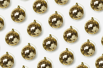 Creative pattern with golden mirror balls on whitebackground, bright sparkling disco ball as Christmas toy, New Year party concept. Background for Christmas, xmas, winter holiday