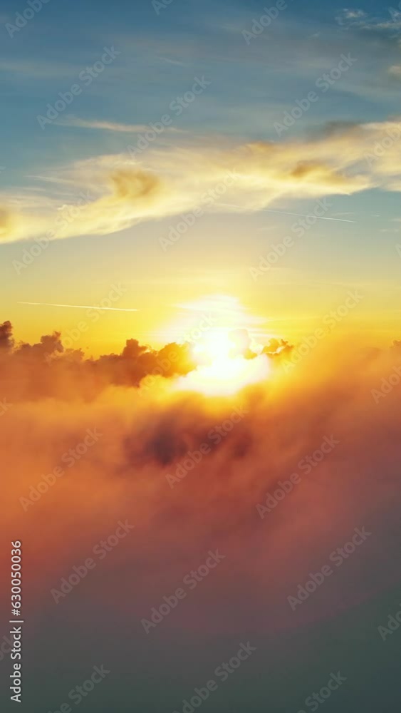 Wall mural flying above the clouds. aerial view of clouds and sunset sun. traveling by air perfect background. 
