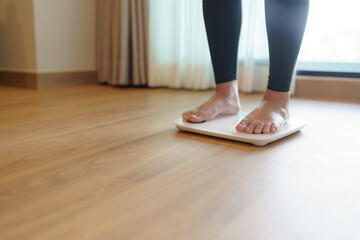 Lose weight. Fat diet and scale feet standing on electronic scales for weight control. Measurement instrument in kilogram for diet.