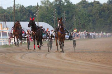 Fototapeta na wymiar Horses and riders running at horse races