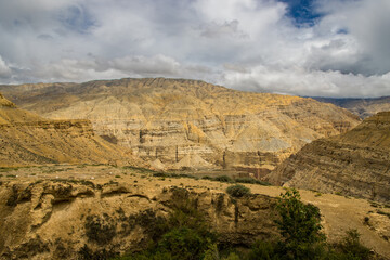 Breathtaking Cloudy Desert Landscape of Upper Mustang captured from Chele Village in Himalaya Nepal