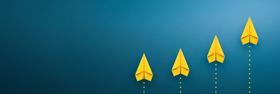 Yellow paper plane on blue background, Success in business growth concept. copy space
