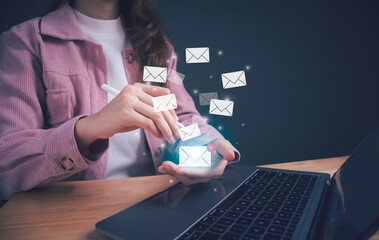 Businesswoman hand holding e-mail icon letter. Business e-mail communication and digital marketing. Inbox receiving electronic message alert. E-mail in virtual screen. New email notification concept.